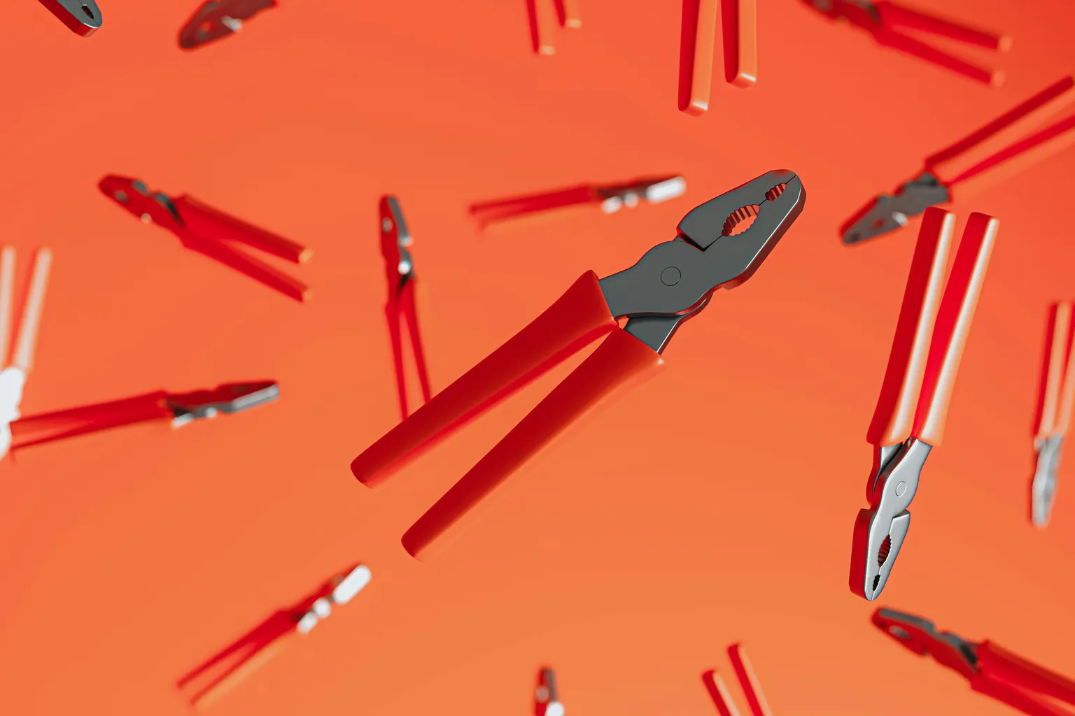 Des pinces à poignées rouges suspendues sur un fond orange, l'une au premier plan, nette, les autres floues.